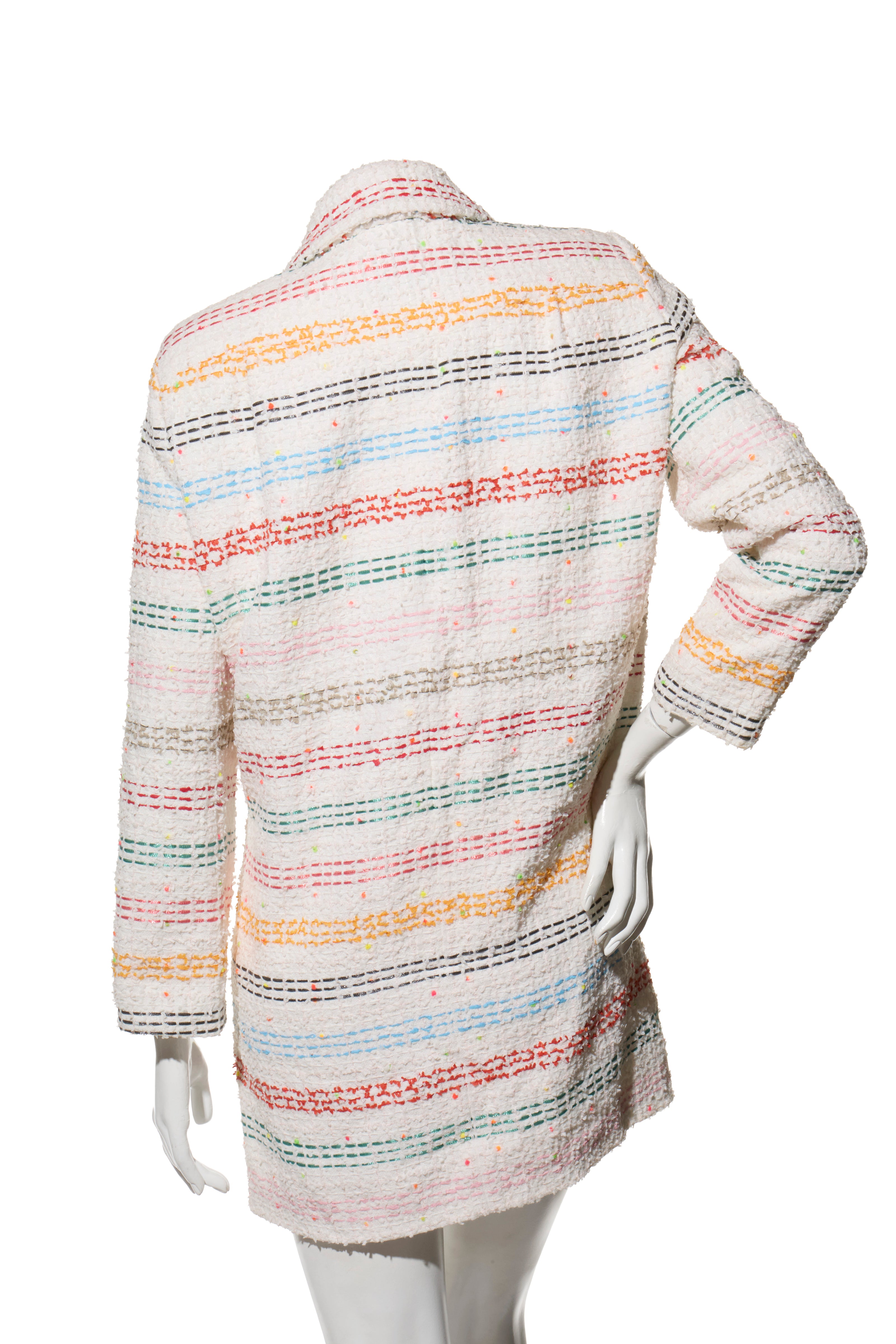 Chanel Spring 2019 rainbow striped tweed coat on a mannequin against a white background back view.