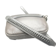 Close up of Chanel metallic silver bum bag showing leather interwoven chain strap detail and luxury hardware finish.