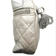 Side angle view of Chanel metallic silver quilted bum bag showing top zip closure with CC zipper pull and softly textured metallic leather.