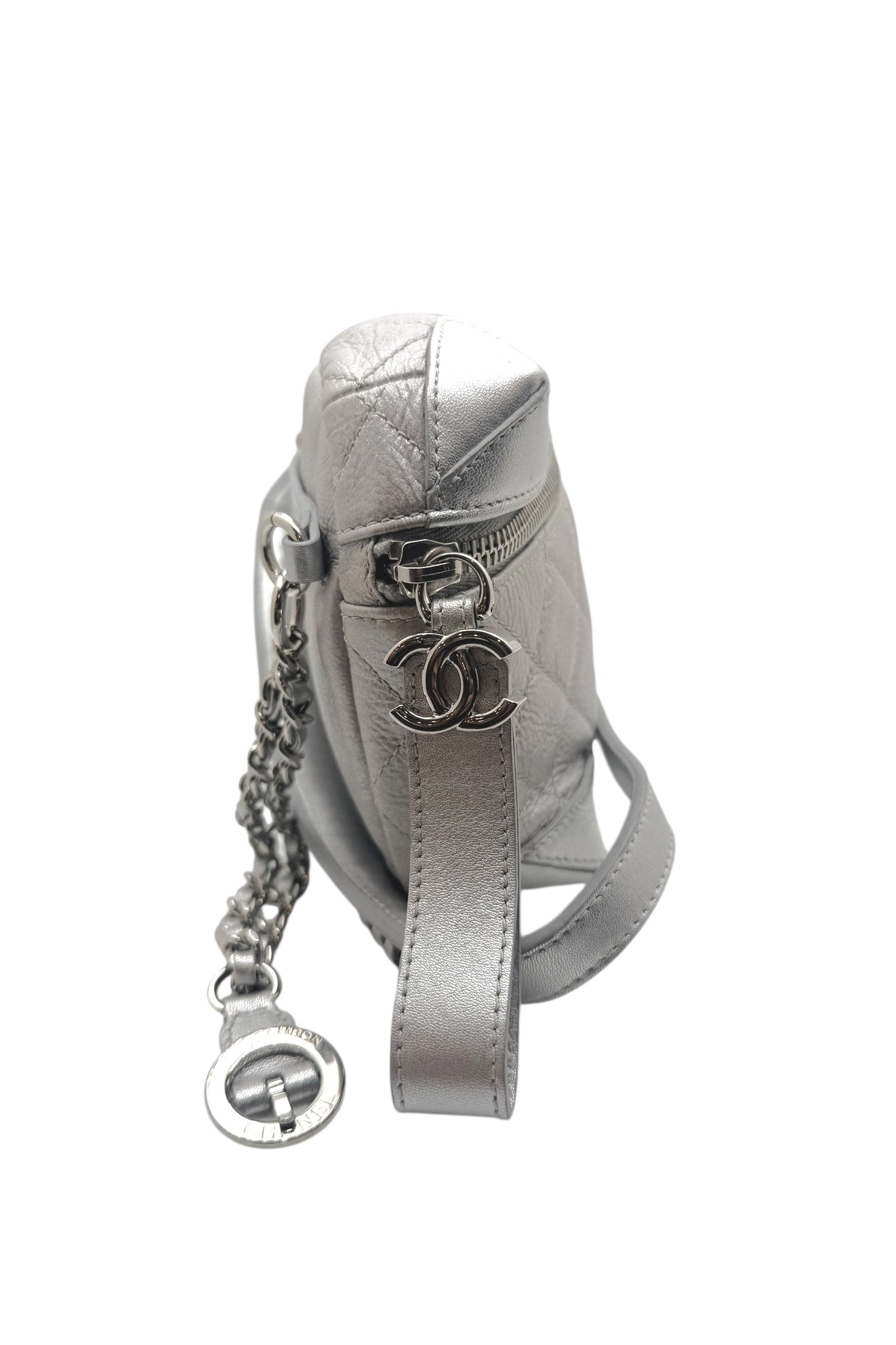 Side profile of Chanel Spring Summer 2017 metallic silver bum bag highlighting silver tone CC logo hardware and quilted leather texture.