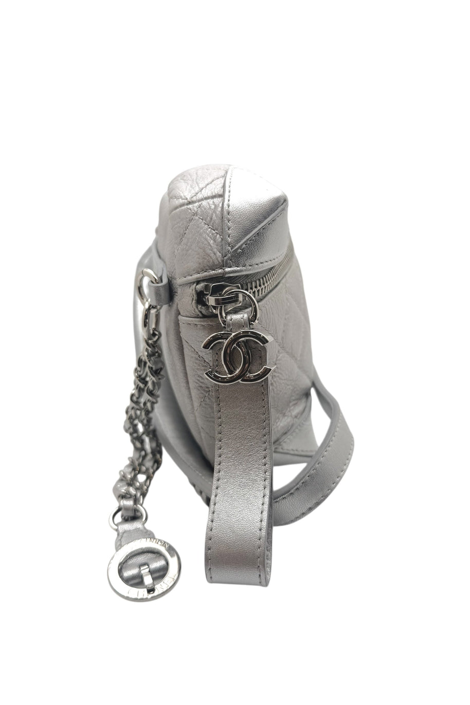 Side profile of Chanel Spring Summer 2017 metallic silver bum bag highlighting silver tone CC logo hardware and quilted leather texture.