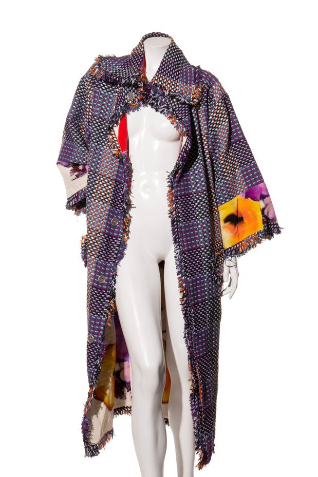 Mannequin wearing a colorful, patterned Chanel coat with floral designs on a white background