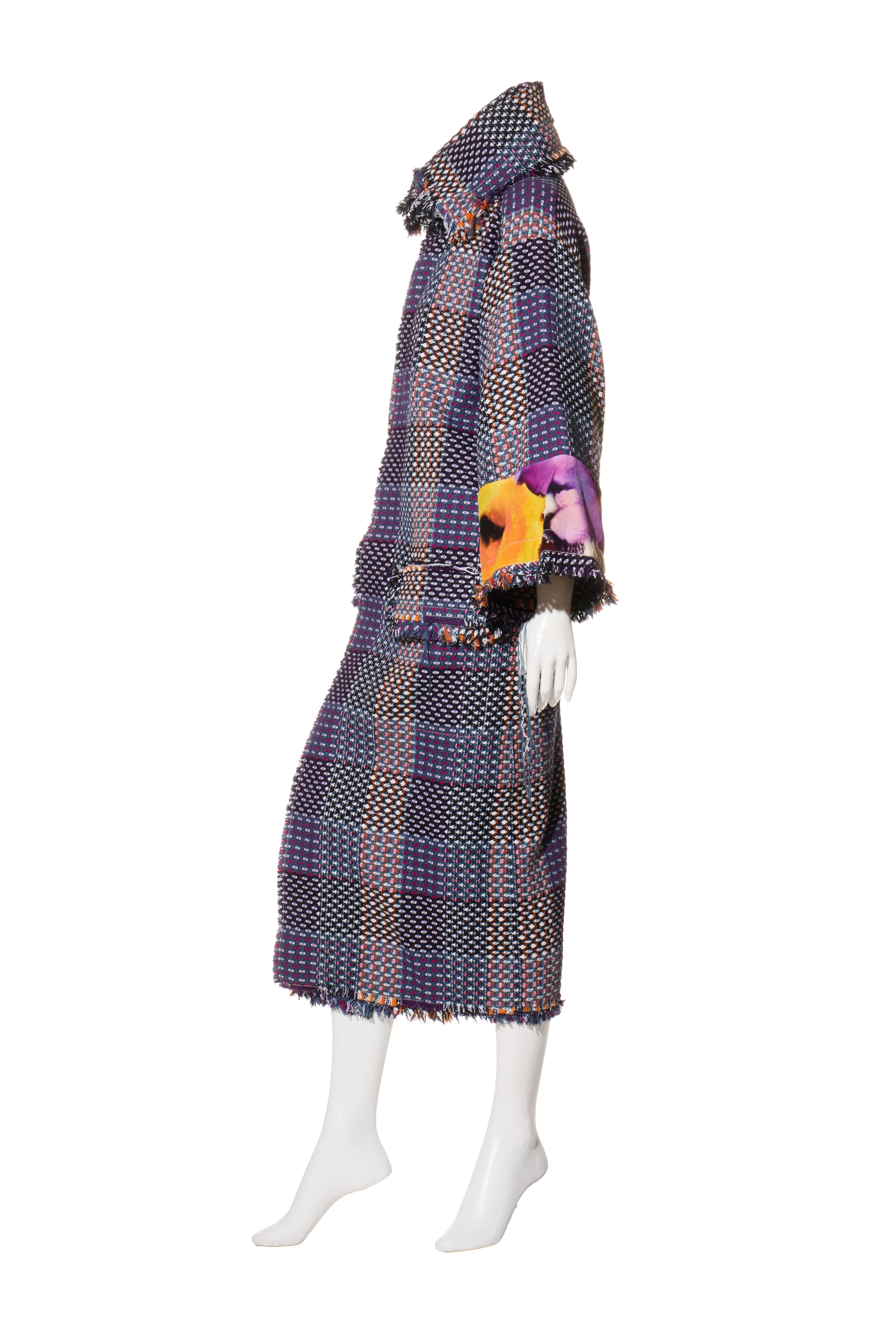 Mannequin wearing a Chanel tweed patterned coat with a Scarf Style Neck on a white background