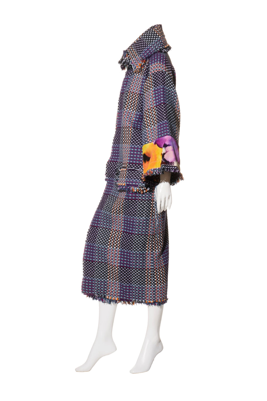 Mannequin wearing a Chanel tweed patterned coat with a Scarf Style Neck on a white background