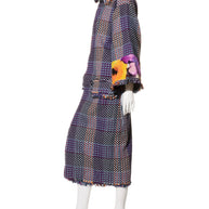 Mannequin wearing a Chanel tweed patterned coat with a Scarf Style Neck on a white background