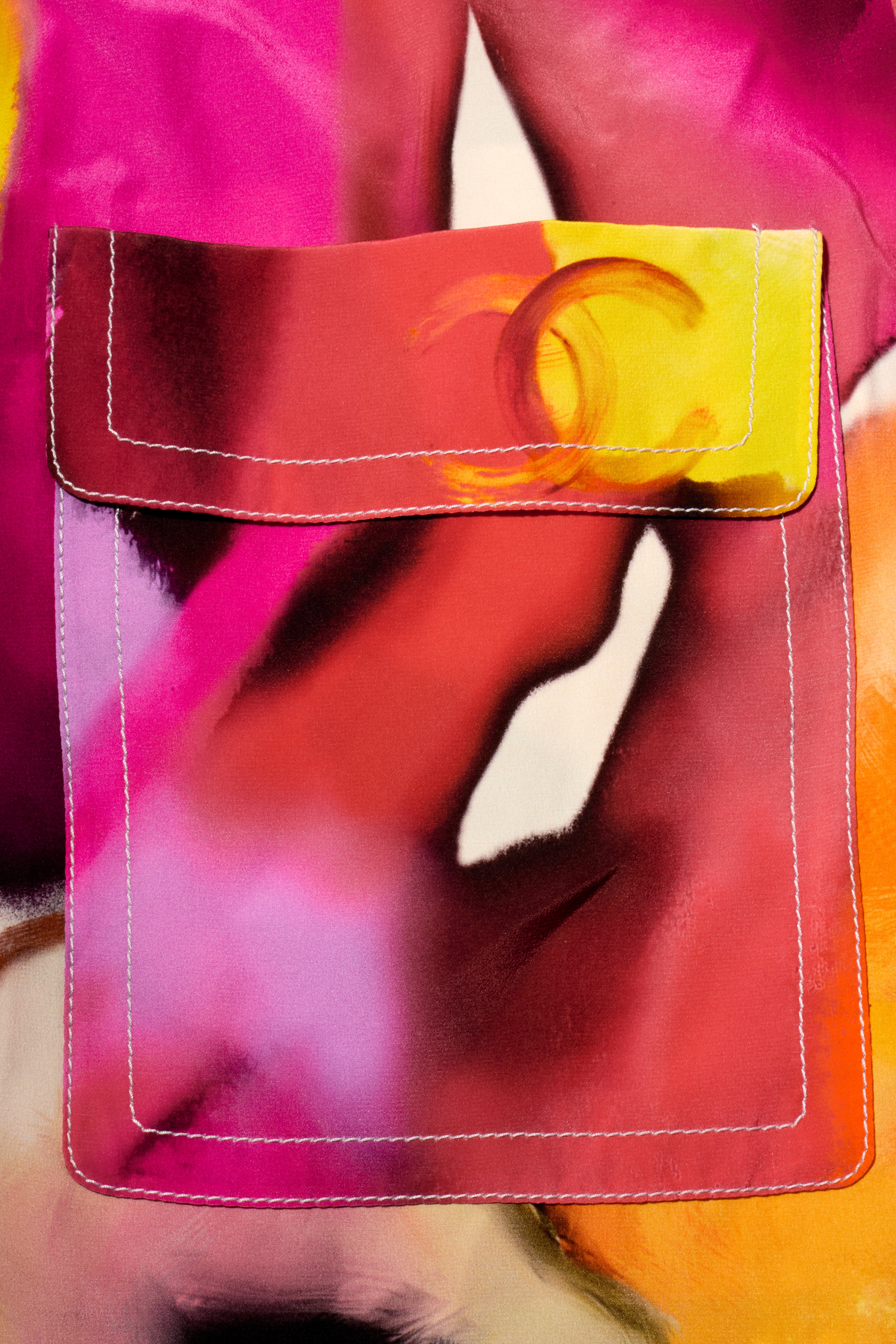 Close-up of Chanel reversible coat floral print pocket with interlocking C's detail.