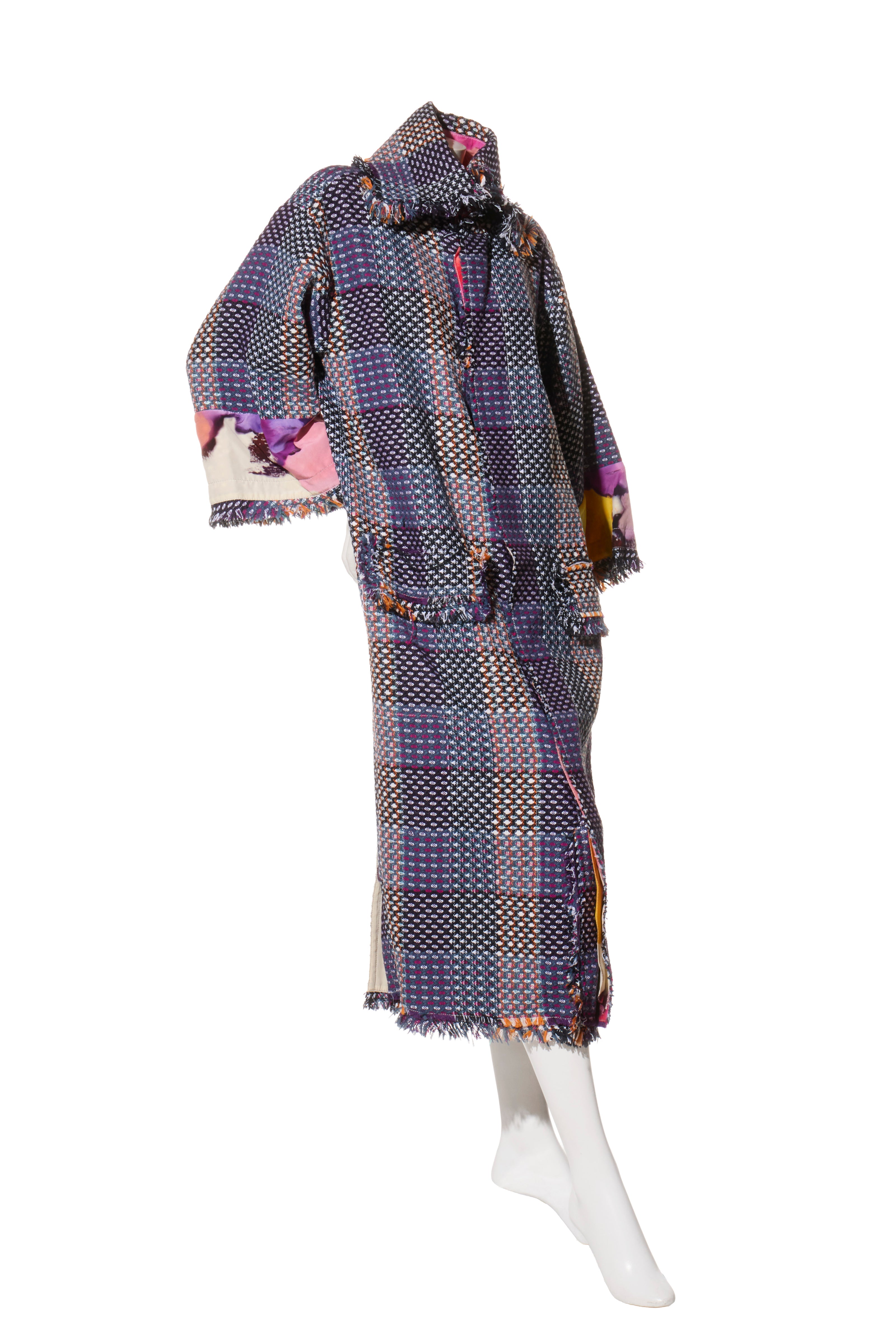 Chanel Tweed Coat on a mannequin facing right angled against a white background