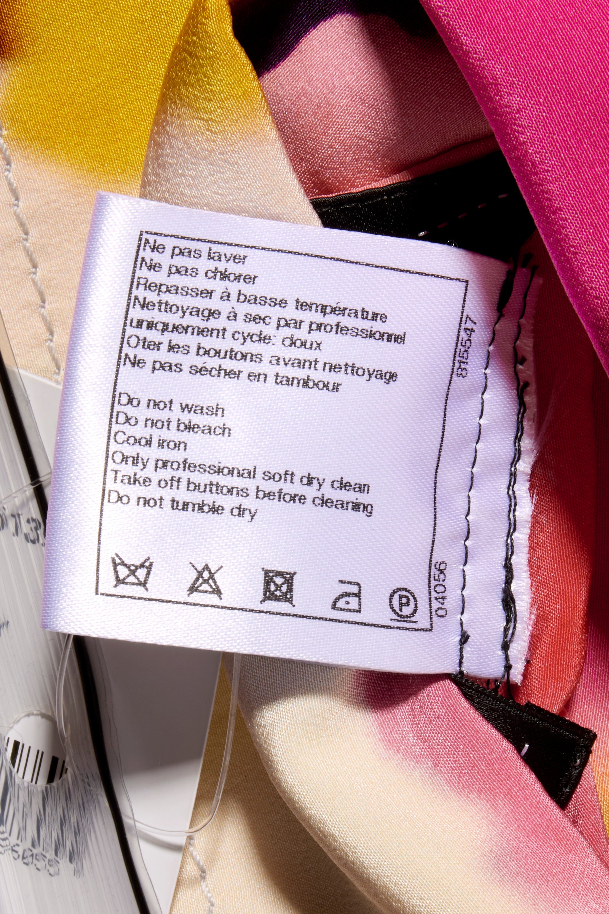 Chanel Tweed Reversible Coat Clothing label wash tag with care instructions attached to the garment floral colorful side interior pocket.