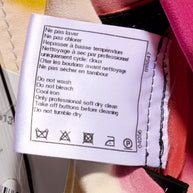 Chanel Tweed Reversible Coat Clothing label wash tag with care instructions attached to the garment floral colorful side interior pocket.