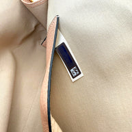 Close-up of interior authenticity hologram tag inside Chloé Alphabet blush leather pouch.