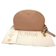 Chloé Alphabet blush leather pouch displayed with original dust bag and authenticity card, showcasing luxury designer cosmetic case.