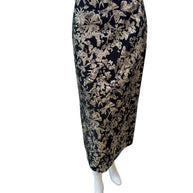 Front view of Christian Dior black midi skirt with gold metallic floral jacquard pattern, high-waisted pencil silhouette, made in Italy.