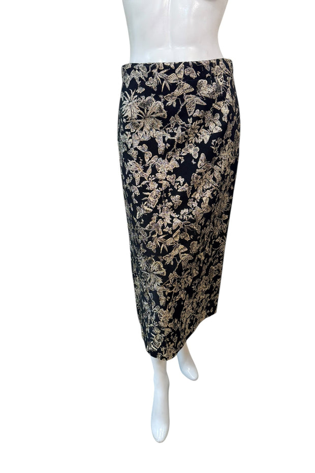 Front view of Christian Dior black midi skirt with gold metallic floral jacquard pattern, high-waisted pencil silhouette, made in Italy.