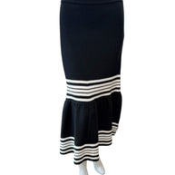 Front view of Christian Dior black knit fluted midi skirt featuring high-waisted fitted silhouette and ivory stripe detailing at the hem.