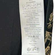 Close-up of Christian Dior skirt care label showing size FR 36 US 4 and metallic jacquard fabric composition.