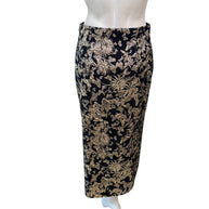 Back view of Christian Dior black and gold metallic floral jacquard midi skirt showing smooth tailoring and clean lines.