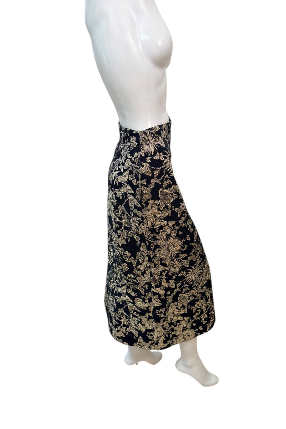 Side profile of Christian Dior metallic floral jacquard midi skirt highlighting tailored pencil silhouette and structured fabric.
