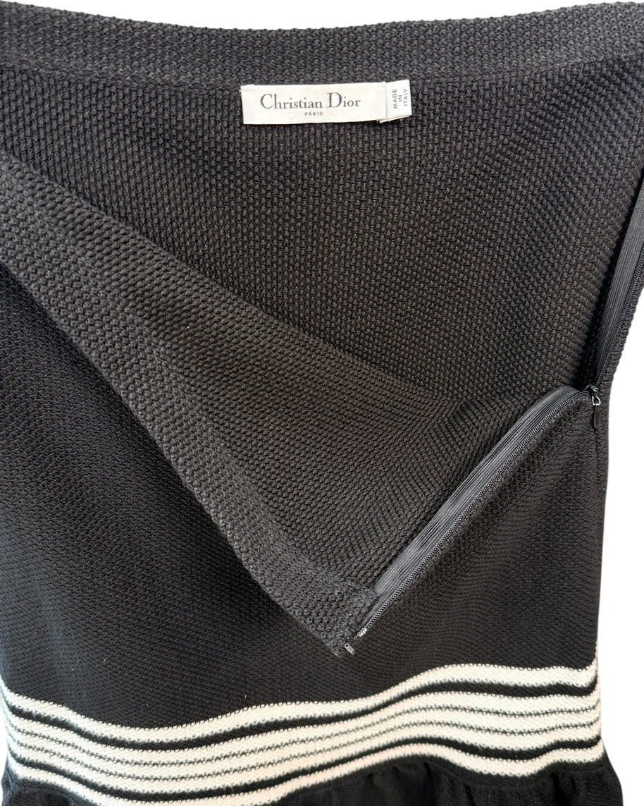Close-up of Christian Dior knit skirt showing textured cotton-silk fabric and concealed back zipper closure.