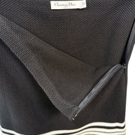 Close-up of Christian Dior knit skirt showing textured cotton-silk fabric and concealed back zipper closure.