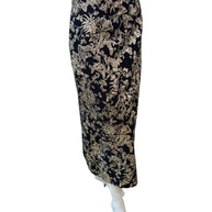 Angled front view of Christian Dior black and gold metallic floral jacquard midi skirt showing fitted high-waist and sleek pencil cut.