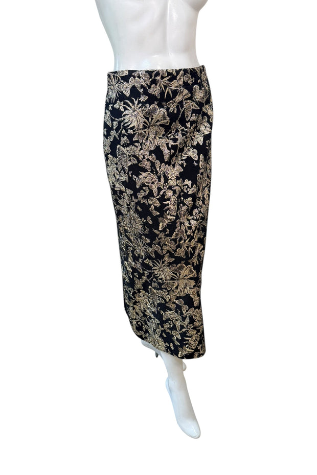 Angled front view of Christian Dior black and gold metallic floral jacquard midi skirt showing fitted high-waist and sleek pencil cut.