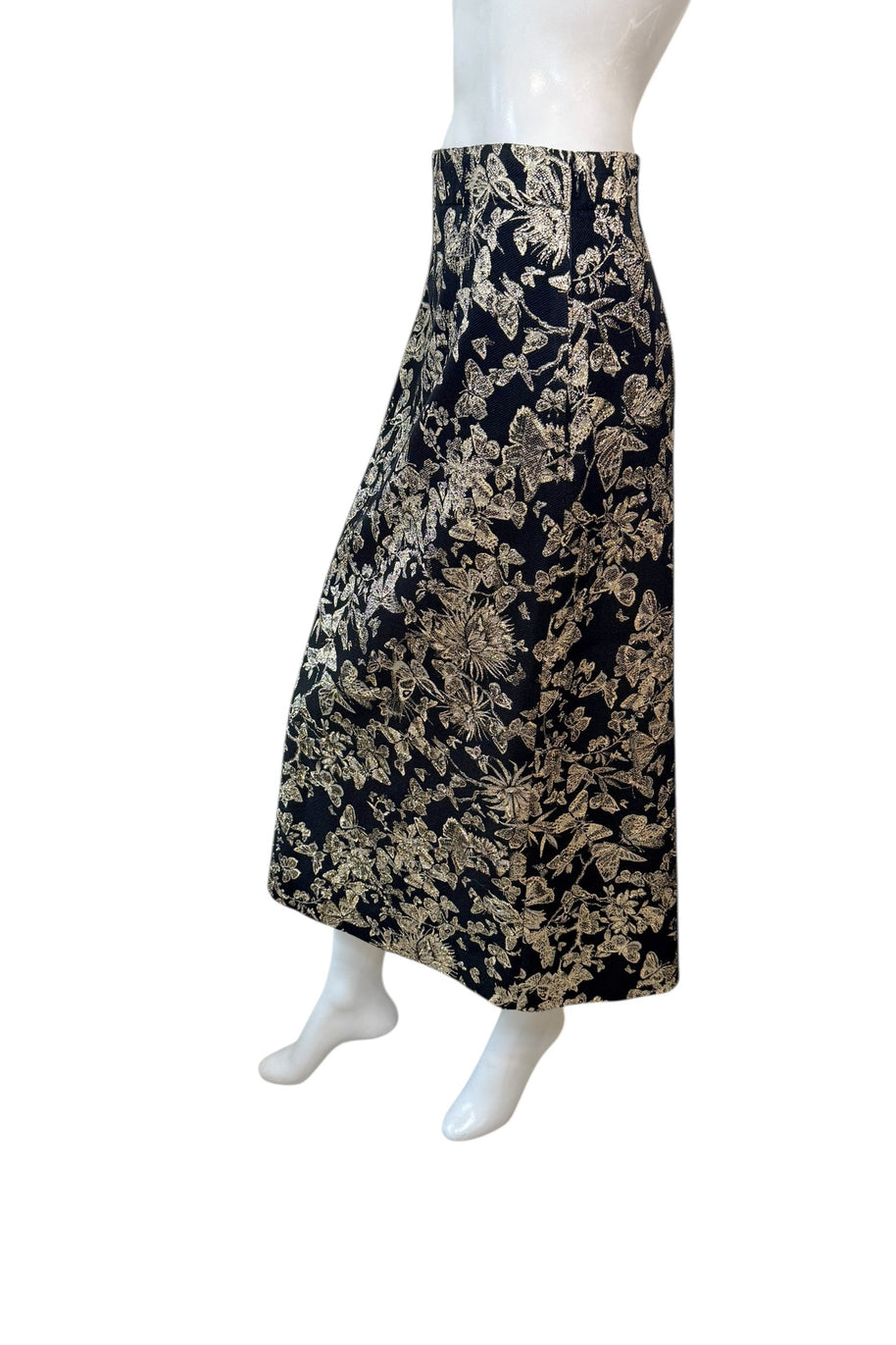 Side-back angle of Christian Dior metallic floral jacquard midi skirt showcasing elegant drape and fitted high-waisted design.