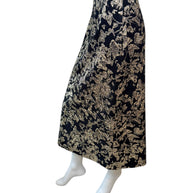 Side-back angle of Christian Dior metallic floral jacquard midi skirt showcasing elegant drape and fitted high-waisted design.