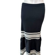 Back view of Dior black knit fluted midi skirt highlighting smooth fitted silhouette and ivory stripe accents.
