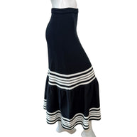 Profile angle of Christian Dior knit midi skirt emphasizing high waist, structured fit, and flared hem movement.