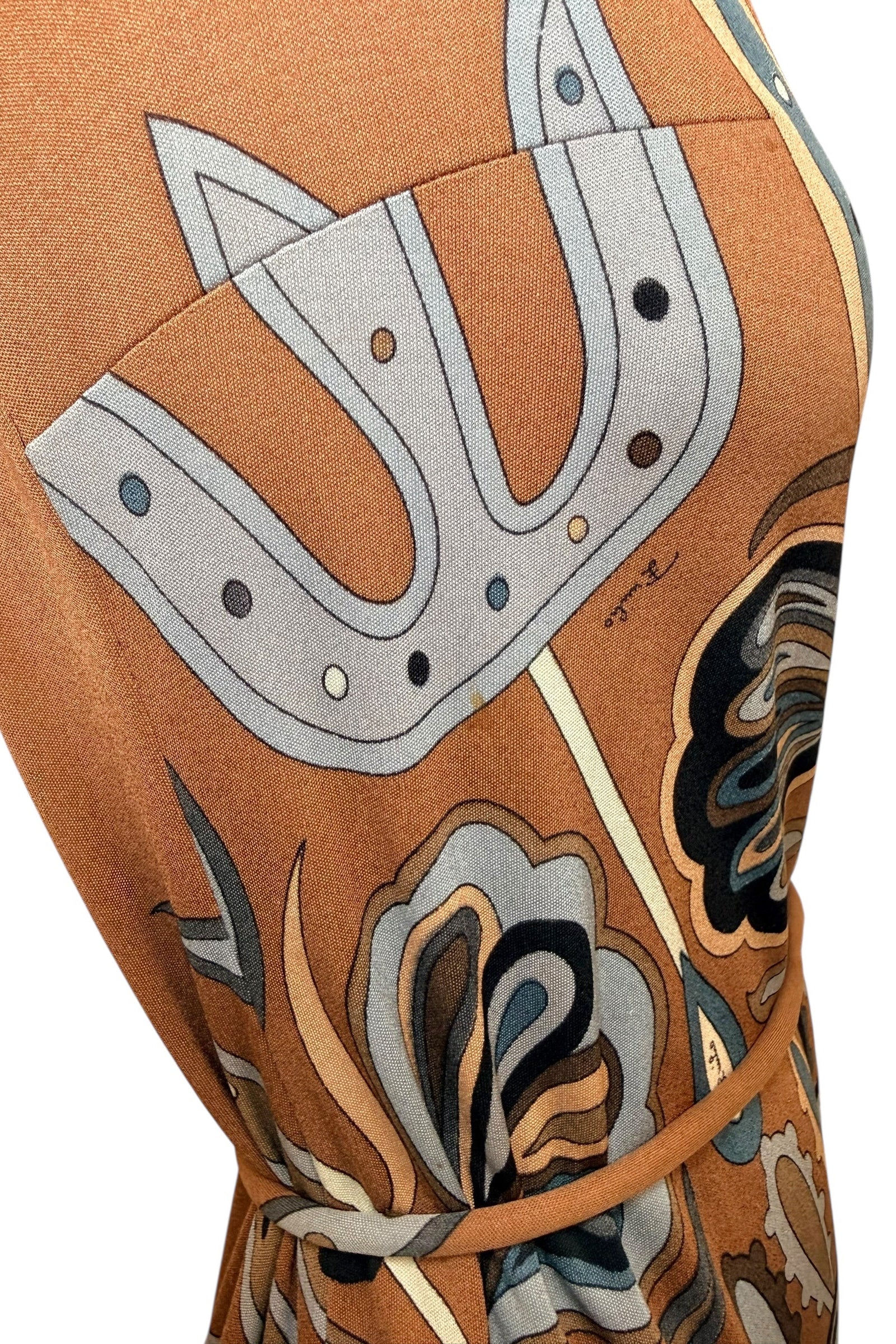 Close-up of Emilio Pucci vintage psychedelic geometric print fabric in brown, camel and blue tones with emphasis on light staining. 