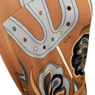 Close-up of Emilio Pucci vintage psychedelic geometric print fabric in brown, camel and blue tones with emphasis on light staining. 