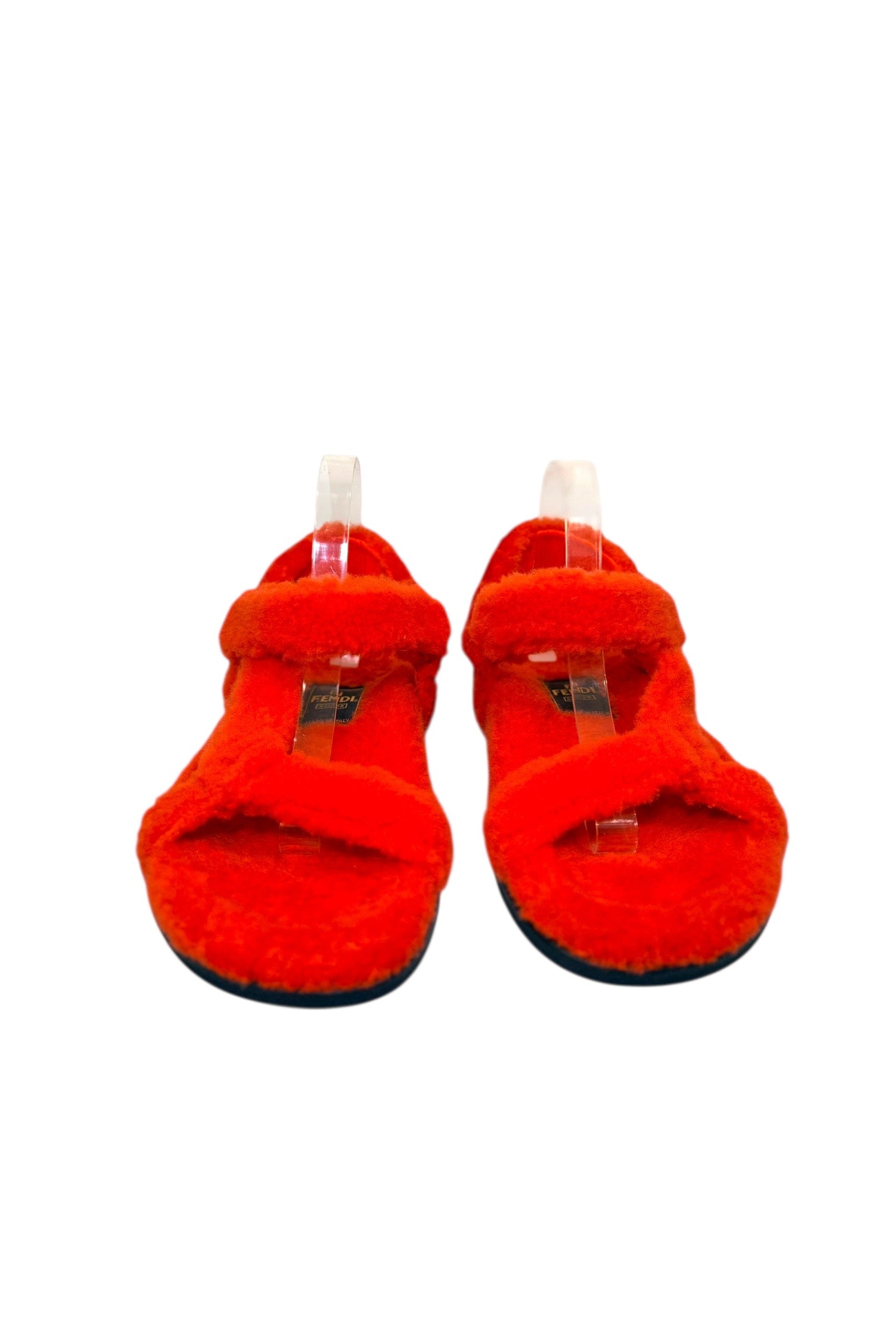 Front view of Fendi red shearling sandals showing crossover straps and open toe design