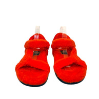 Front view of Fendi red shearling sandals showing crossover straps and open toe design