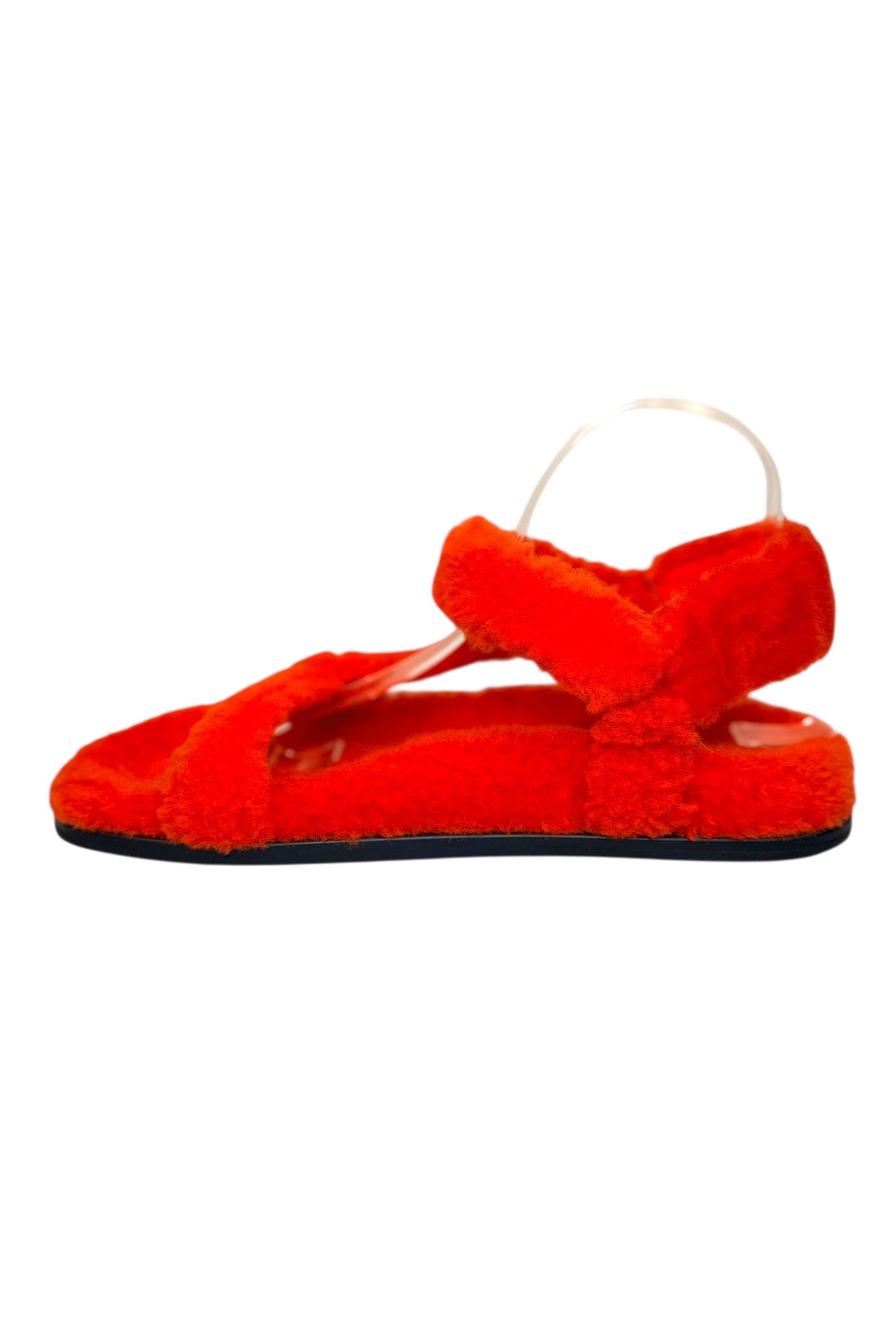 Right side view of Fendi red shearling flat sandals with ankle strap and cushioned shearling footbed
