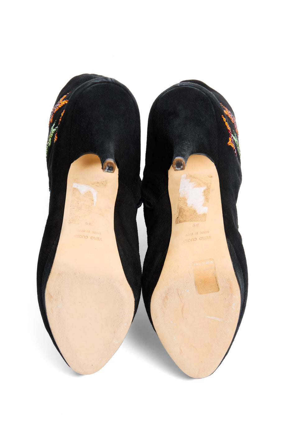 Pair of Giuseppe Zanotti black suede ankle boot shoes with bejeweled star embellishments view of soles with size '39' and 'made in italy' stamped into soles on a white background