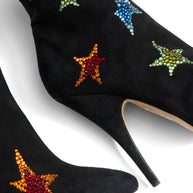 Giuseppe Zanotti Black high-heeled suede shoes close up of colorful star embellishments on a white background