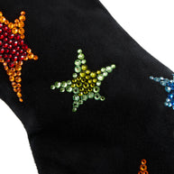 Black suede Giuseppe Zanotti Boot close up view of colorful star patterns on a white background