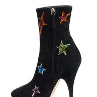 Black Giuseppe Zanotti ankle boot with colorful star embellishments left shoe inside view with zip detail on a white background