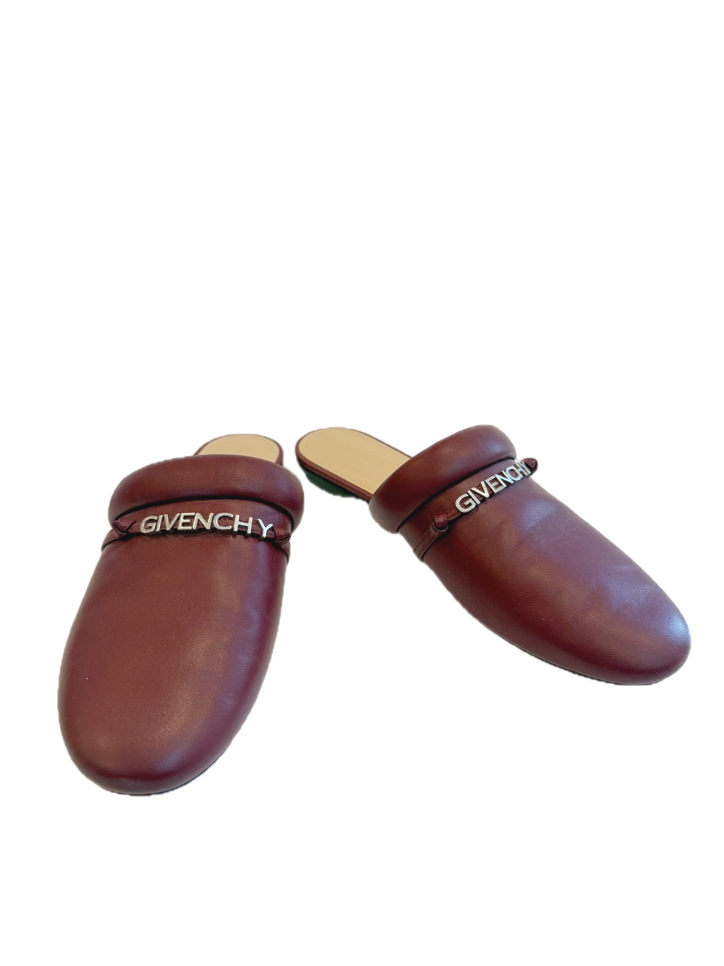 Pair of Givenchy burgundy leather slides slippers on a white background