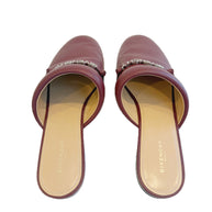 Pair of Givenchy burgundy slides on a white background