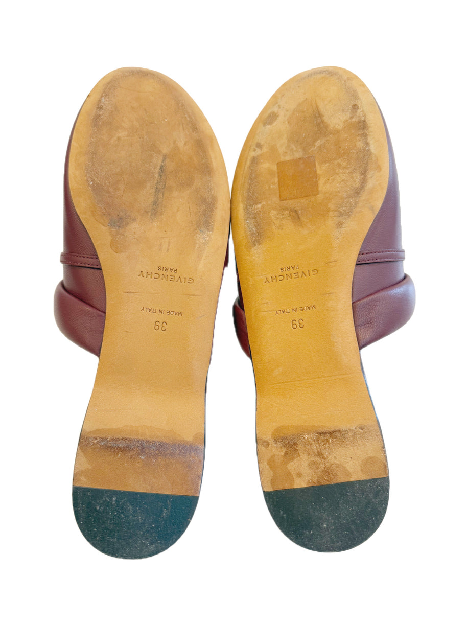 Givenchy pre-loved burgundy leather slides with visible wear on the soles against a white background