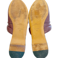 Givenchy pre-loved burgundy leather slides with visible wear on the soles against a white background