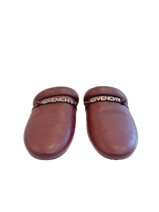 Pair of Givenchy burgundy leather slides on a white background