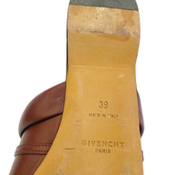 Close-up of a Givenchy burgundy slide shoe sole with 'Made in Italy' and 'Givenchy Paris' and '39' text.