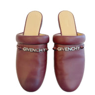 Pair of Givenchy burgundy leather slides on a white background