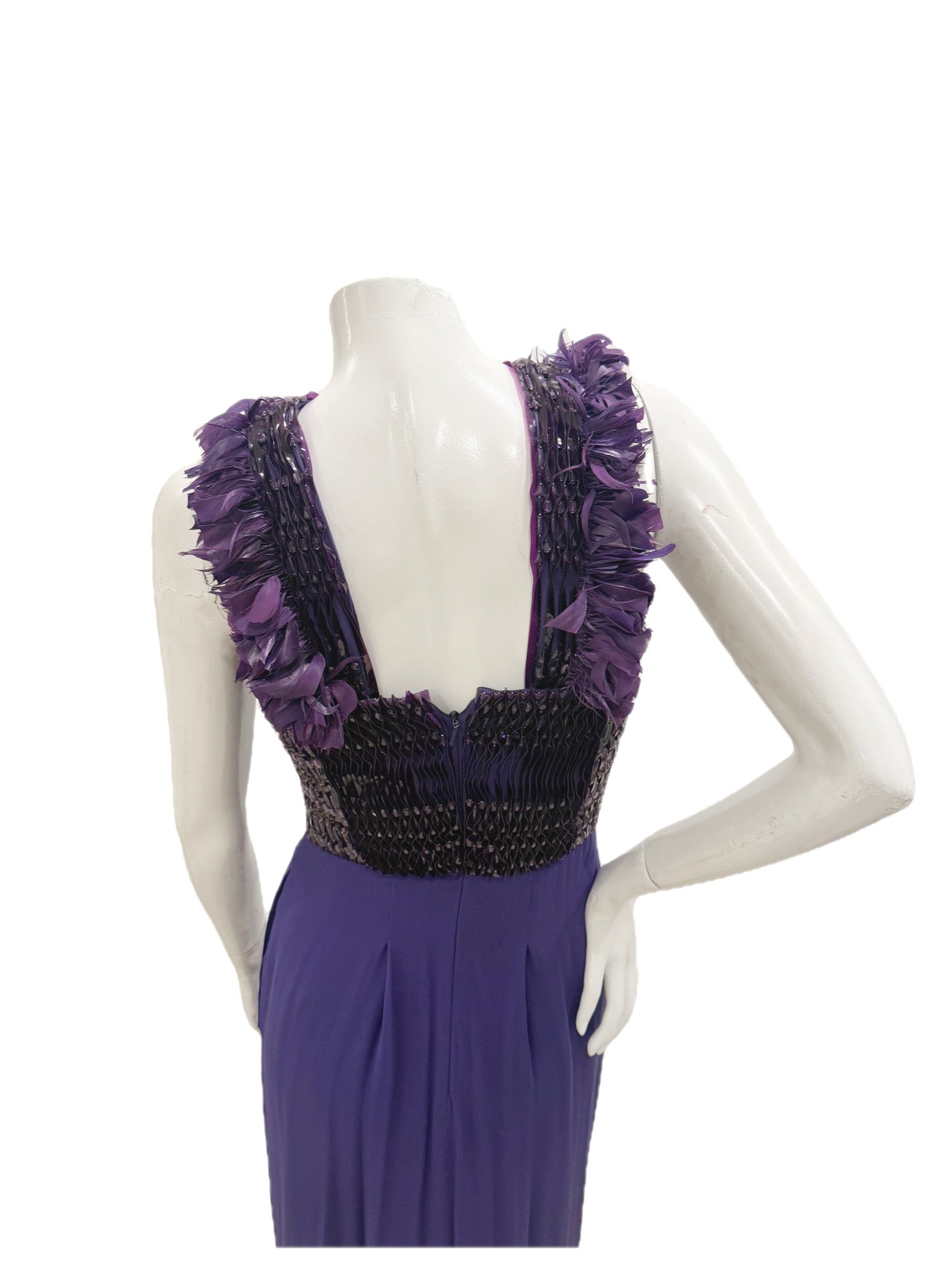 Close-up of the back bodice on Gucci gown showing beading, pleating, and feather trim.