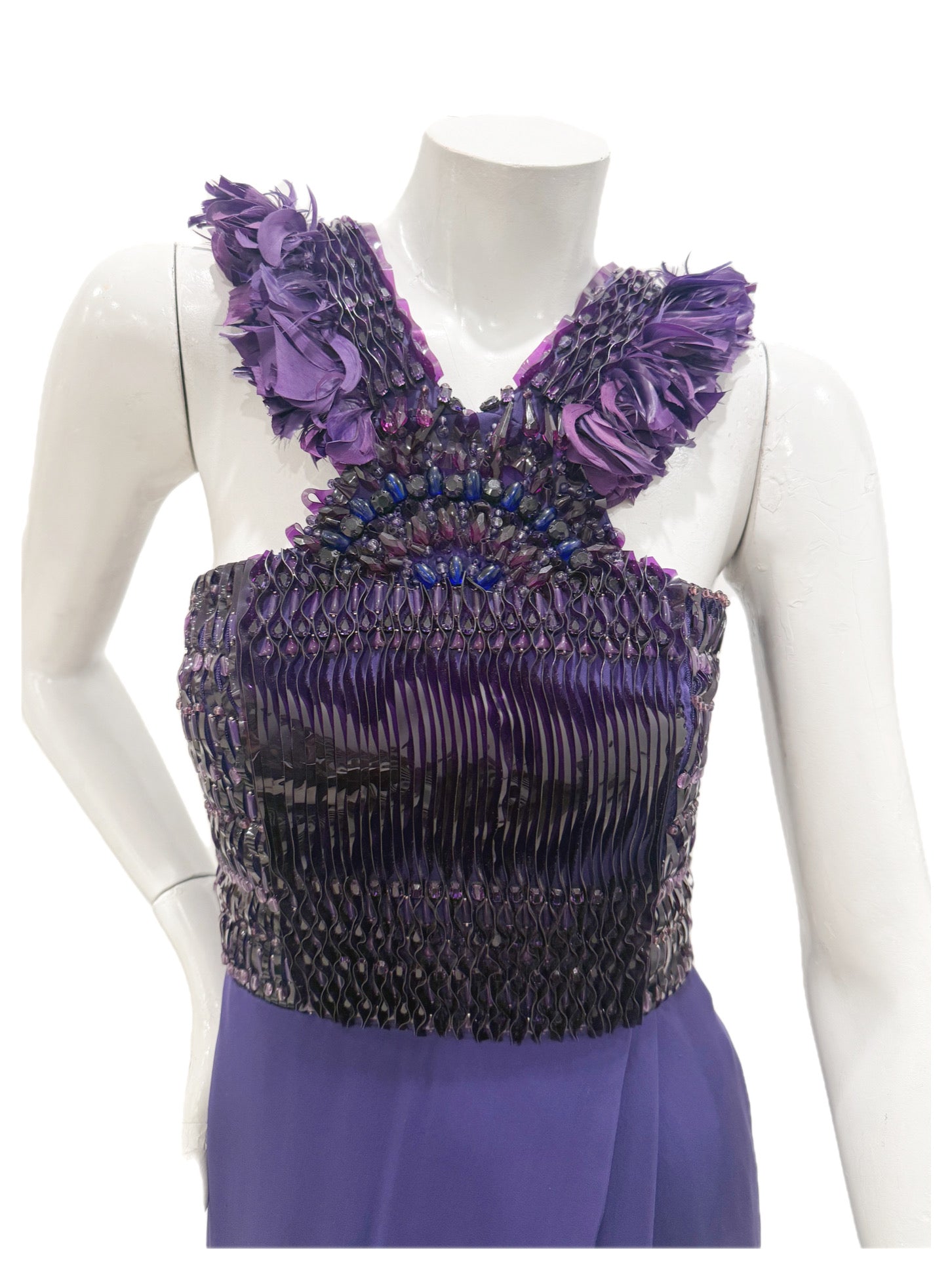 Close-up of Gucci gown bodice showing pleated satin, beadwork, and purple feather embellishments.