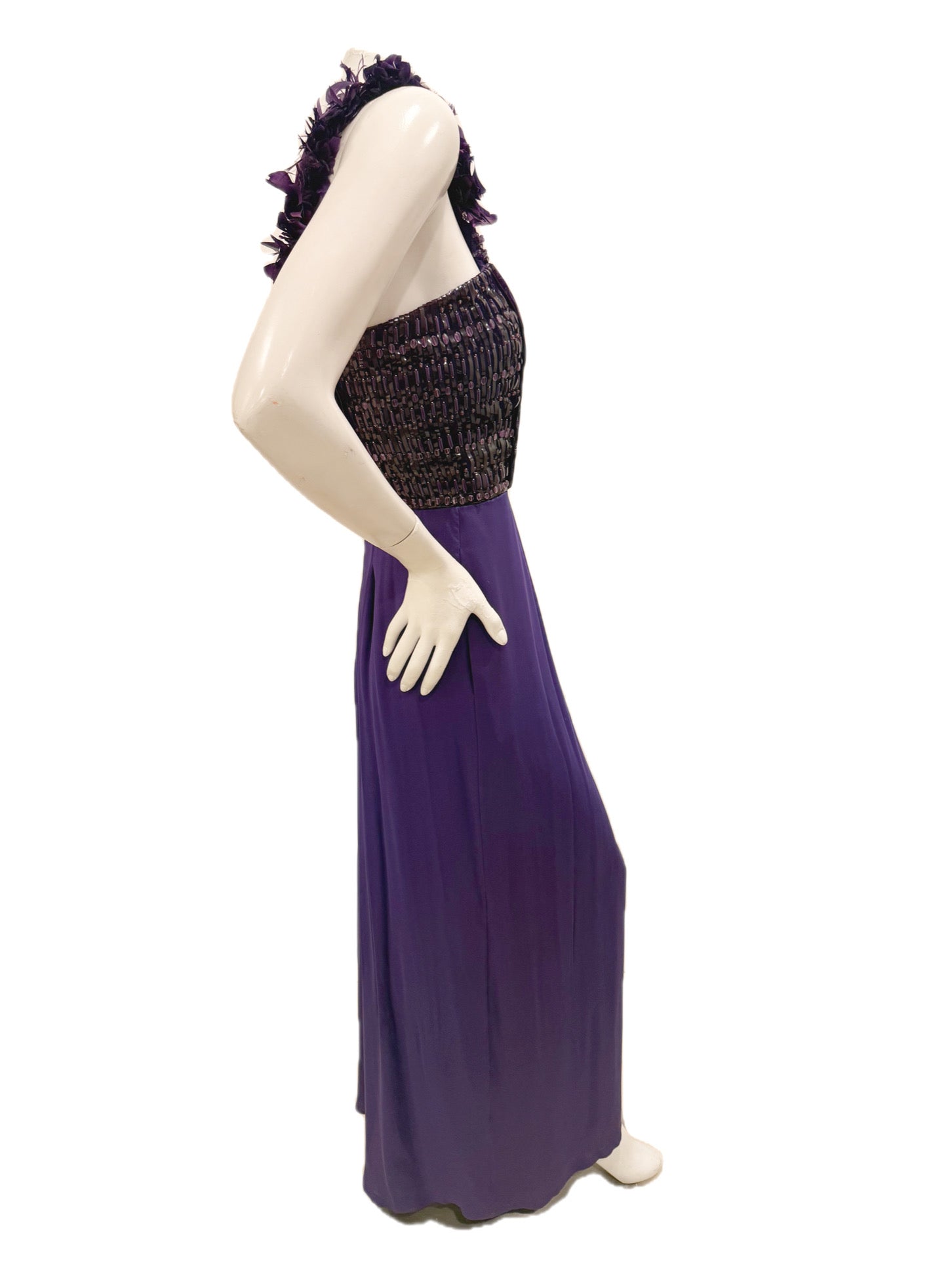 Side view of Gucci purple evening gown showing fitted embellished bodice and draped skirt.