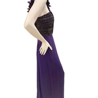 Side view of Gucci purple evening gown showing fitted embellished bodice and draped skirt.