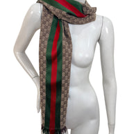Gucci GG monogram web stripe scarf styled over shoulder on mannequin, luxury Italian accessory